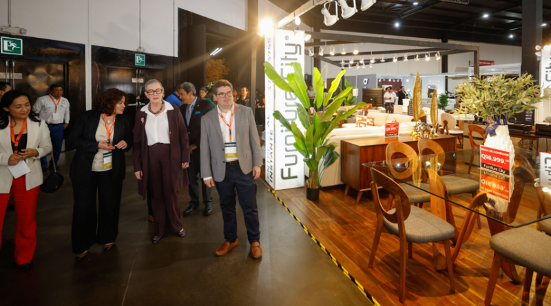 Participantes recorren una exposición de muebles y productos de madera.